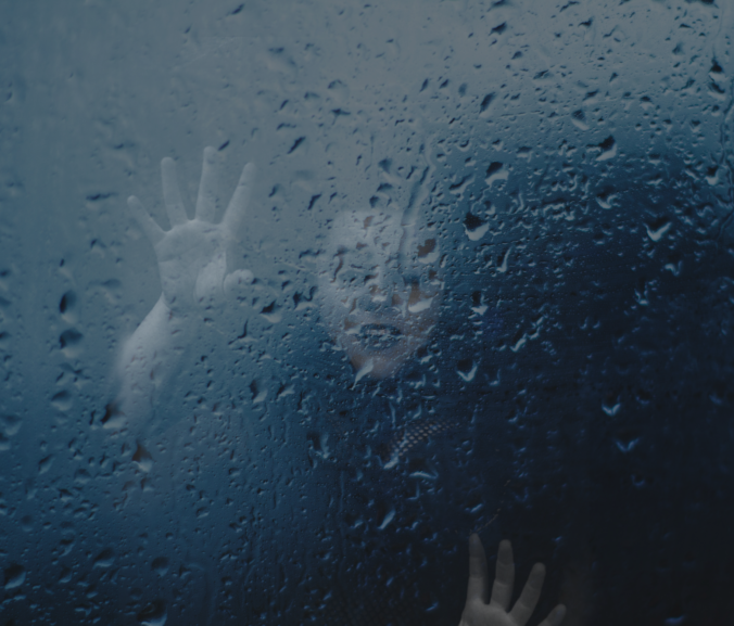 Woman falling into blackness behind glass sprinked with rain